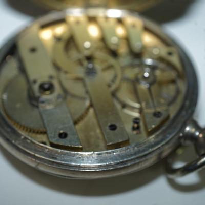 Sale Photo Thumbnail #126: antique pocket watch. silverplated /case coin? 
Case: 52810
no markings found inside the works, 
bezel and crystal intact and in good condition 
key wind- key is missing, 
The watch is selling as is. Not working 
engraved case of trees and cottage on one 