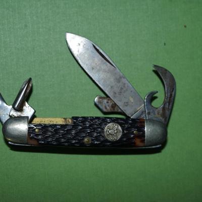 Sale Photo Thumbnail #154: two boyscout pocket knives. One is an Imperial the other is an Ulster,
One is a bone handle the other is a wood handle with a ridged finish,
See photos of the blades displayed open
the blades and metal are soiled and need cleaning, the collector has their