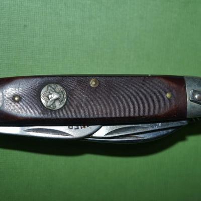 Sale Photo Thumbnail #151: two boyscout pocket knives. One is an Imperial the other is an Ulster,
One is a bone handle the other is a wood handle with a ridged finish,
See photos of the blades displayed open
the blades and metal are soiled and need cleaning, the collector has their