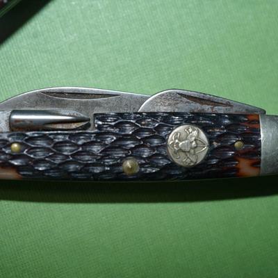 Sale Photo Thumbnail #150: two boyscout pocket knives. One is an Imperial the other is an Ulster,
One is a bone handle the other is a wood handle with a ridged finish,
See photos of the blades displayed open
the blades and metal are soiled and need cleaning, the collector has their