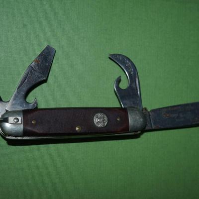 Sale Photo Thumbnail #153: two boyscout pocket knives. One is an Imperial the other is an Ulster,
One is a bone handle the other is a wood handle with a ridged finish,
See photos of the blades displayed open
the blades and metal are soiled and need cleaning, the collector has their