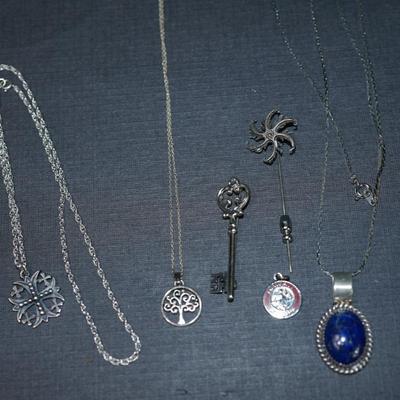 Sale Photo Thumbnail #156: Grouping of 6 jewelry items stamped sterling. 
The weight (without the sterling framed lapis pendant by Verna Craig ) is 20 grams. I didnt include the pendant because of the stone setting 
The chains  on two of them are sterling but not the Verna Craig ne