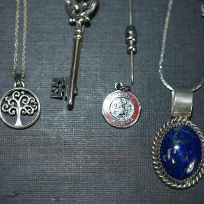 Sale Photo Thumbnail #158: Grouping of 6 jewelry items stamped sterling. 
The weight (without the sterling framed lapis pendant by Verna Craig ) is 20 grams. I didnt include the pendant because of the stone setting 
The chains  on two of them are sterling but not the Verna Craig ne
