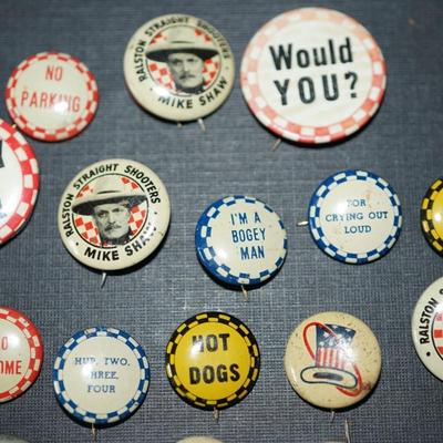 Sale Photo Thumbnail #169: vintage cereal box pins and other. 1940's and up. 
Roy Rogers and Mike Shaw pins included
20 in all . They measures from 1/2" to 1" round, 
condition is good for the age. Some slight wear and discoloration to a few