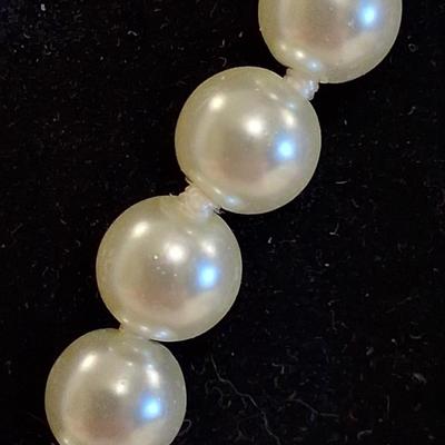 Sale Photo Thumbnail #116: Necklace is marked on clasp as pictured. I believe these are hand knotted cultured white pearls. I can not say for sure. They pass all the home tests but I have not taken them to a jeweler. 

Comes complete with its own keepsake bag. Is supposed to help r