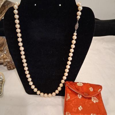 Sale Photo Thumbnail #121: I believe these to be Cultured pearls. They have passed all the home tests but have not been checked by a Jeweler. All hand knotted, marked on clasp as pictured. 

Comes complete with Silk keepsake pouch. It is supposed to help keep the color bright if st