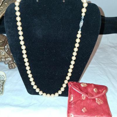 Sale Photo Thumbnail #122: I believe these to be Cultured pearls. They have passed all the home tests but have not been checked by a Jeweler. All hand knotted, marked on clasp as pictured. 

Comes complete with Silk keepsake pouch. It is supposed to help keep the color bright if st