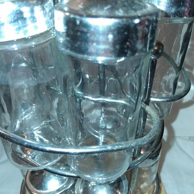 Sale Photo Thumbnail #147: Glass Jars with Metal(?) Lids. Wood & Metal & Wood rotating Holder. Great condition. Appears as if one jar is missing but there isn't.  Came with an empty slot.
