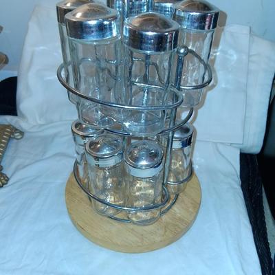 Sale Photo Thumbnail #146: Glass Jars with Metal(?) Lids. Wood & Metal & Wood rotating Holder. Great condition. Appears as if one jar is missing but there isn't.  Came with an empty slot.