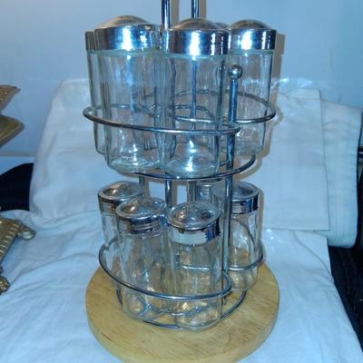 Sale Photo Thumbnail #150: Glass Jars with Metal(?) Lids. Wood & Metal & Wood rotating Holder. Great condition. Appears as if one jar is missing but there isn't.  Came with an empty slot.