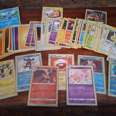 Sale Photo Thumbnail #176: 50 Random Cards. May include Holos, Japanese,  Rares, Commons & more
Sleeves shown are included.