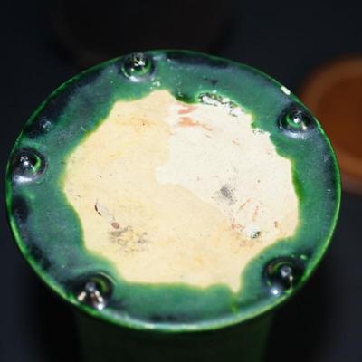 Sale Photo Thumbnail #178: a 12" vintaGE cyclinder form vase. matt green slip glaze with yellow color. 
The base is a yellow clay glazed. 
no markings found. 
Good condition. a few factory flaws along the top edge but these are not chips. 
Very classic looking piece.