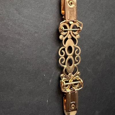 Fashion Sweden gold-tone metal swirly design rhinestone sweater or dress clip.