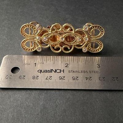 Fashion Sweden gold-tone metal swirly design rhinestone sweater or dress clip.