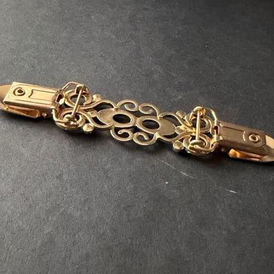 Fashion Sweden gold-tone metal swirly design rhinestone sweater or dress clip.