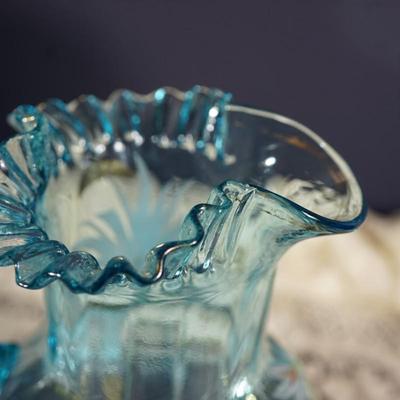 Sale Photo Thumbnail #188: This is a possible Northwood glass pitcher and four glasses from the 1890's-1900.
Beautiful blue glass with hand painted glasses and pitcher of exotic stylized flowers
brush gold colored leaves ( slight wear to a few of these) the enamelled dots accent. N