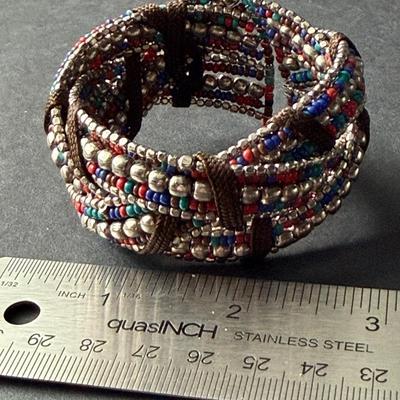 red and blue with silvertone beads criss-cross stretch cuff bracelet.