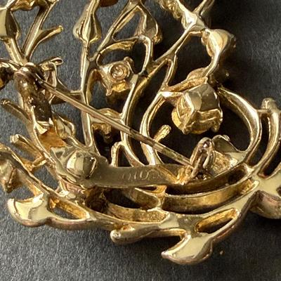 Vintage Coro vintage gold-tone and multicolor rhinestone floral bouquet brooch.