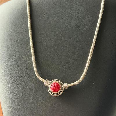 Beautiful silver tone fashion necklace with red center
