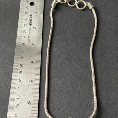 Beautiful silver tone fashion necklace with red center