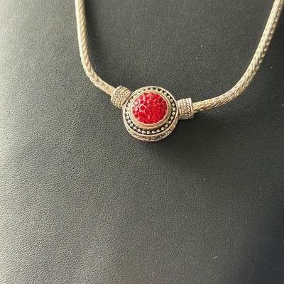 Beautiful silver tone fashion necklace with red center