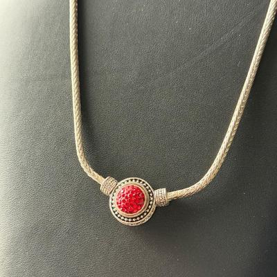Beautiful silver tone fashion necklace with red center