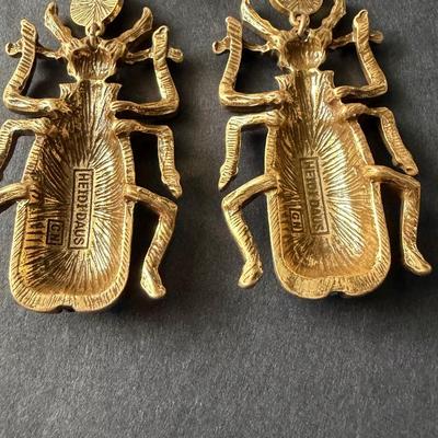 Heidi Daus blue beetle rhinestone statement earrings.