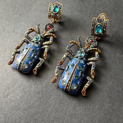 Heidi Daus blue beetle rhinestone statement earrings.