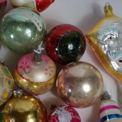 Sale Photo Thumbnail #207: Grouping of Christmas ornaments. 
the paint is off on some of them. They have signs of wear but still a good selection 
No breakage. Some may have the metal tops missing but overall interesting selection 
most are mercury blown and hand decorated.