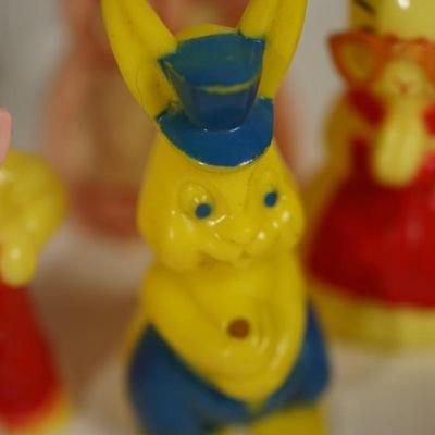 Sale Photo Thumbnail #220: grouping of plastic rabbits 6", 5" and 3" 
plastic little yellow chick at 3" 
two paper machine rabbits vintage 6" and 5"  -chips.   areas of missing paint. see photo 
the little basket is a vintage hand woven basket. measures about 7" in height good cond
