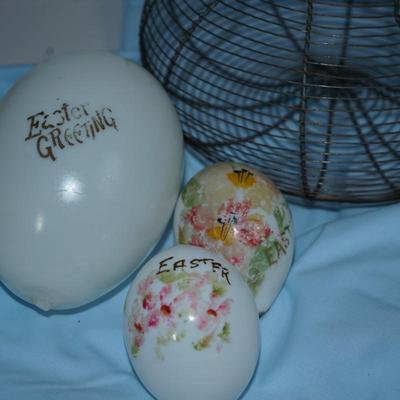 Sale Photo Thumbnail #228: original antique wire collecting basket. 
Four various sizes of milkglass decorated hand blown eggs. 
The paint is partially off on some of the eggs but still have the charm of a craft of the early 20th century 
The wire basket is 8"in height with out the