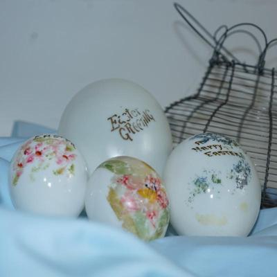 Sale Photo Thumbnail #222: original antique wire collecting basket. 
Four various sizes of milkglass decorated hand blown eggs. 
The paint is partially off on some of the eggs but still have the charm of a craft of the early 20th century 
The wire basket is 8"in height with out the