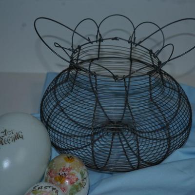 Sale Photo Thumbnail #229: original antique wire collecting basket. 
Four various sizes of milkglass decorated hand blown eggs. 
The paint is partially off on some of the eggs but still have the charm of a craft of the early 20th century 
The wire basket is 8"in height with out the