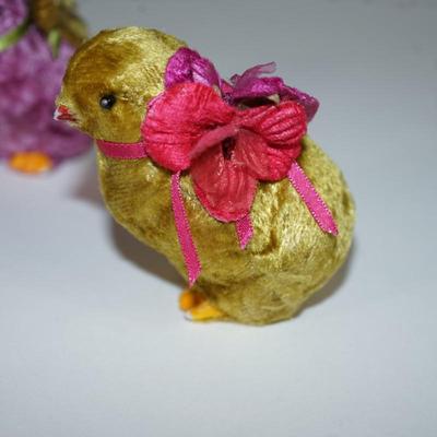 Sale Photo Thumbnail #232: three  chicks covered with a felt fabric , very soft, silk florals and ribbon . little black bead eyes.  and decorated with ribbon and other. The base is a hard white plastic. 
1940- 1950's? 
felt is missing on a few of the feet. two of the beaks have a l