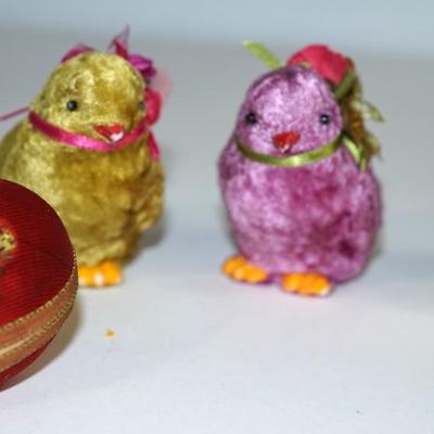Sale Photo Thumbnail #231: three  chicks covered with a felt fabric , very soft, silk florals and ribbon . little black bead eyes.  and decorated with ribbon and other. The base is a hard white plastic. 
1940- 1950's? 
felt is missing on a few of the feet. two of the beaks have a l