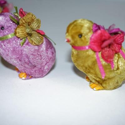 Sale Photo Thumbnail #233: three  chicks covered with a felt fabric , very soft, silk florals and ribbon . little black bead eyes.  and decorated with ribbon and other. The base is a hard white plastic. 
1940- 1950's? 
felt is missing on a few of the feet. two of the beaks have a l