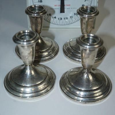 Sale Photo Thumbnail #247: at auction are two pairs of stamped sterling candlholders of 4"
one pair has dings and a few dents in the base, The other pair is in good condition
See scale for total weight . The basket is about 2.1 ounces. 
The 4" sterling weighted candleholders have a