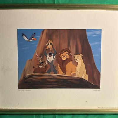 Sale Photo Thumbnail #25: Framed artwork featuring characters Lion King.The scene shows animals atop a rock formation, prominently displaying a lion figure with others nearby. The frame is a simple gold tone with a white mat, providing a classic display. Details about the medium (