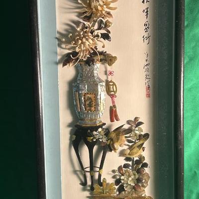 Sale Photo Thumbnail #28: Framed Chinese silk embroidery artwork depicting a vase with botanical elements, decorative objects, and Chinese calligraphy. The piece is enclosed in a slender, black wooden frame with a glass cover. The embroidery uses silk threads in a variety of color