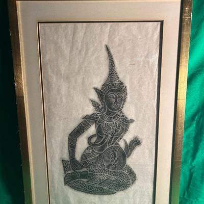 Sale Photo Thumbnail #33: Framed artwork featuring a traditional Thai depiction of a seated figure, created in black ink or graphite on delicate paper. The art is mounted within a double mat and housed in a gold-toned frame. The image showcases intricate patterns and detailing ref