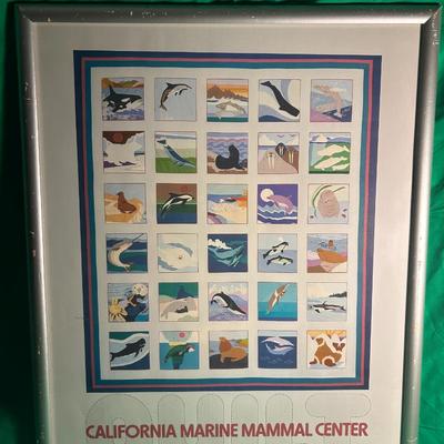 Sale Photo Thumbnail #38: A framed poster advertising the California Marine Mammal Center exhibition at the Monterey Bay Aquarium Cannery Row, dated October 20, 1984. The poster features a grid of colorful illustrations depicting marine mammals in various scenes and settings, enca