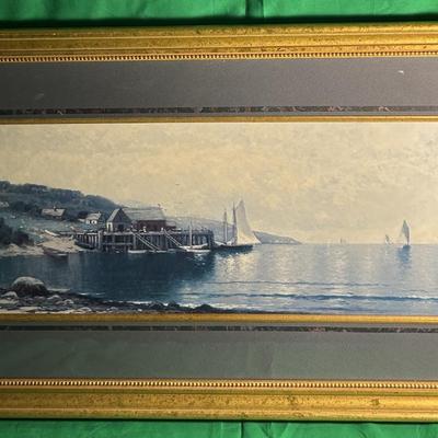 Sale Photo Thumbnail #83: Framed watercolor painting depicting a serene coastal landscape with houses, boats, and a calm sea. The scene features soft lighting, a peaceful atmosphere, and fine details. The artwork is enclosed in a gold-tone wooden frame with a textured finish and a
