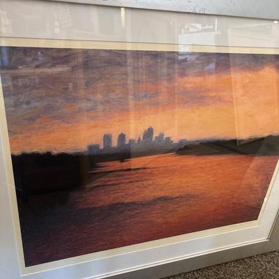 Sale Photo Thumbnail #247: Beautiful colors of the skyline framed in a silver frame measuring 37” x 31.5”. Some damage on frame.