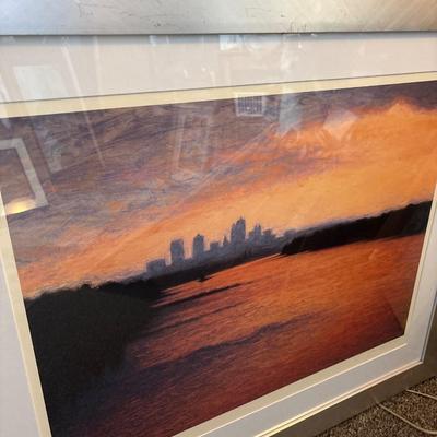Sale Photo Thumbnail #244: Beautiful colors of the skyline framed in a silver frame measuring 37” x 31.5”. Some damage on frame.