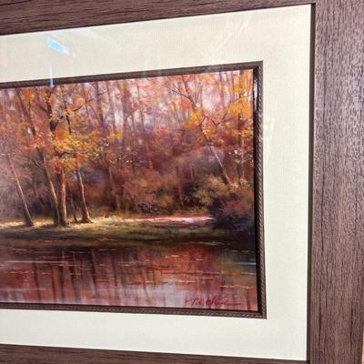 Sale Photo Thumbnail #272: Beautiful fall colors in this pictorial of trees, bridge and water. Print displays a signature. Great frame measuring 44“ x 20“.