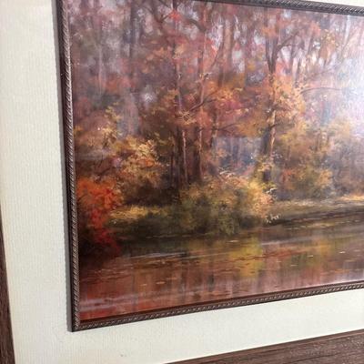 Sale Photo Thumbnail #270: Beautiful fall colors in this pictorial of trees, bridge and water. Print displays a signature. Great frame measuring 44“ x 20“.