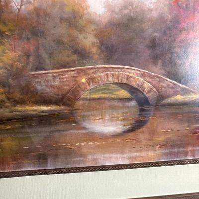 Sale Photo Thumbnail #269: Beautiful fall colors in this pictorial of trees, bridge and water. Print displays a signature. Great frame measuring 44“ x 20“.