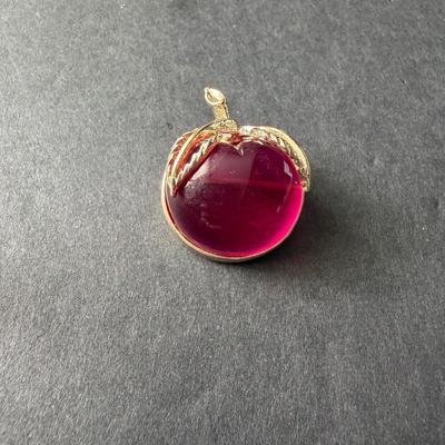 vintage 1972 Sarah Coventry "Burgundy" lucite apple brooch in a gold-tone setting