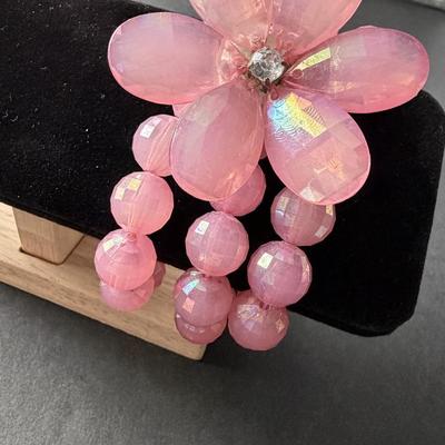Light pink plastic beaded 3 strand with floral middle piece bracelet
