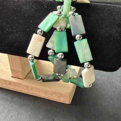 Multi strand green rectangular and white shell type bracelet
